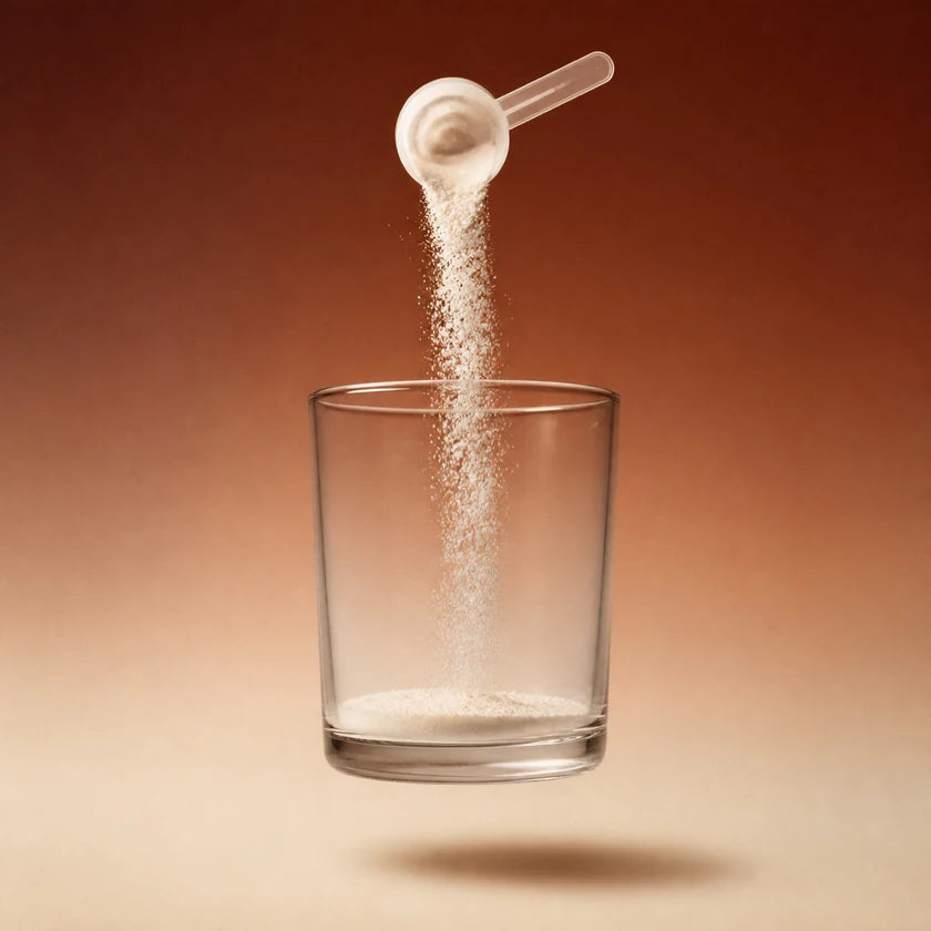 A clear scoop pouring Return Hydration powder into a floating glass against a warm studio backdrop