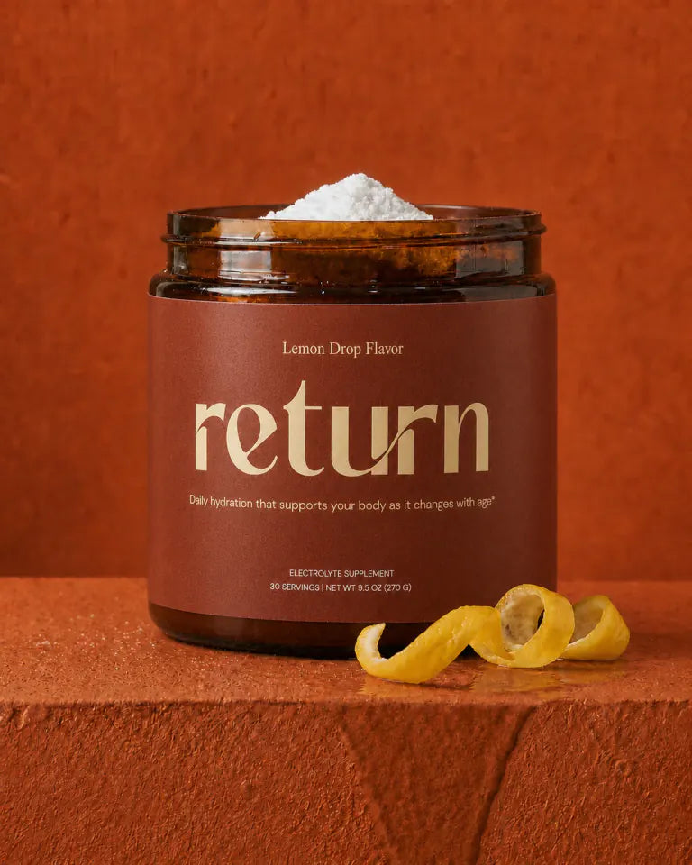 Open Return Hydration Lemon Drop tub with powder and curled lemon peel