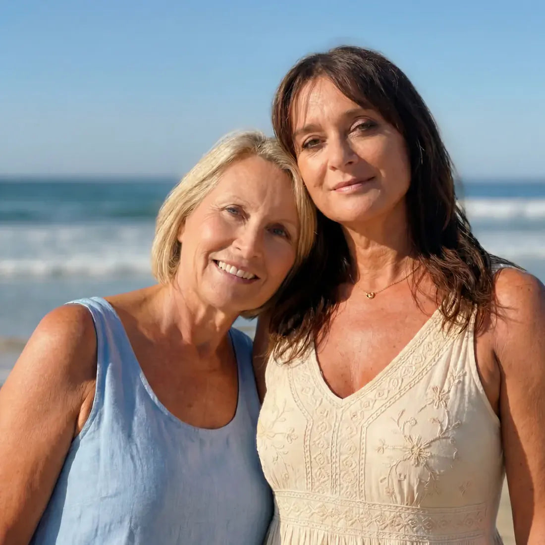 Two women enjoying time together beside the ocean